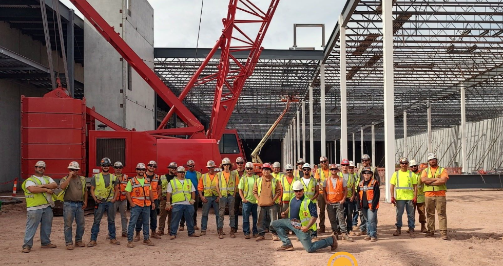 Topping Out Crew celebrates successful completion of structural steel lifting.